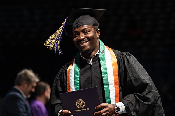 graduate receiving his diploma