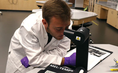 Student looking through microscope