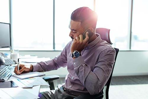 person on phone at their desk