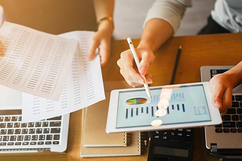 comparing data on table with printed copies