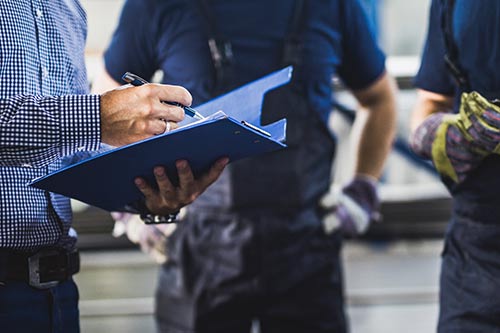 manager looking over report with employees