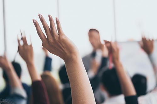 Hands raised during a speech